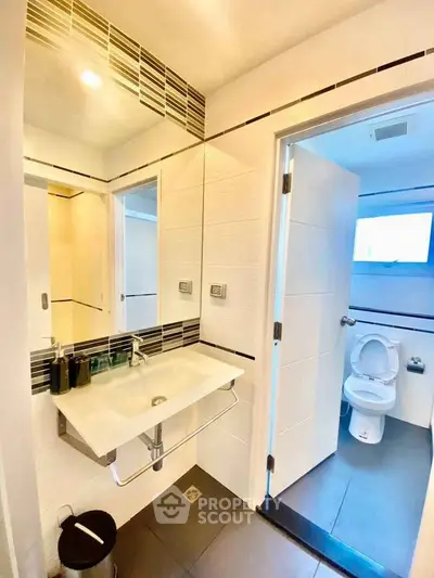 Modern bathroom with sleek design and contemporary fixtures in a stylish apartment.