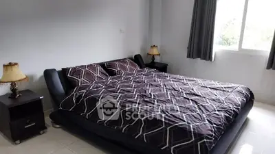 Modern bedroom with stylish decor and ample natural light