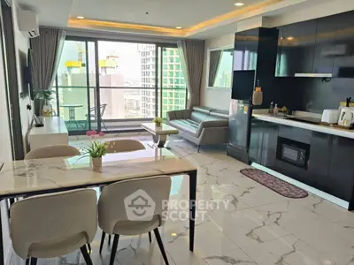 Modern open-plan living room with kitchen and city view balcony, featuring sleek furnishings and marble flooring.