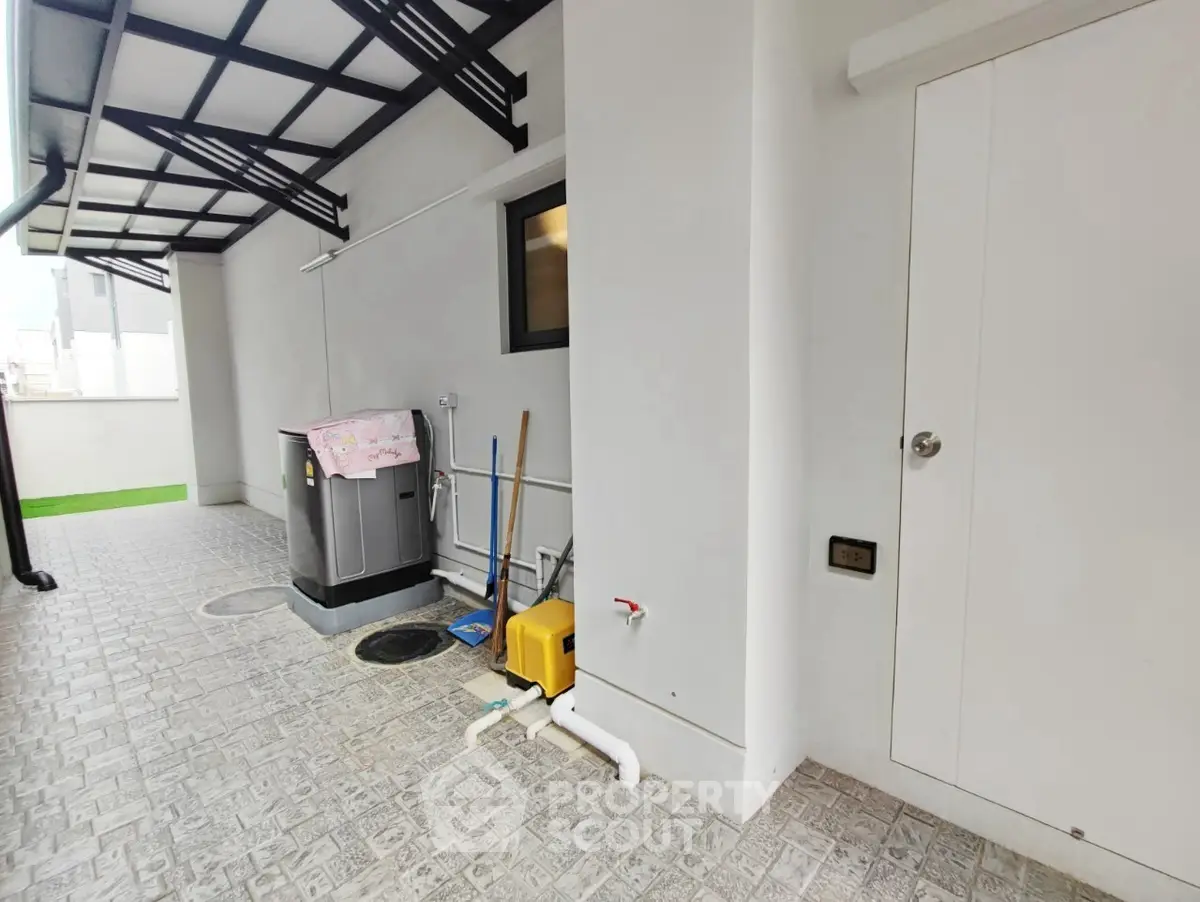 Modern exterior utility area with storage and tiled flooring