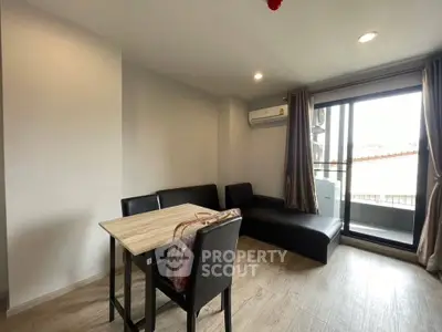 Modern living room with sleek furniture and balcony access in a stylish apartment.