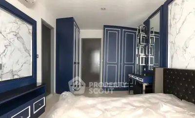 Luxurious bedroom with elegant blue and white decor, featuring a stylish vanity and ample storage space.