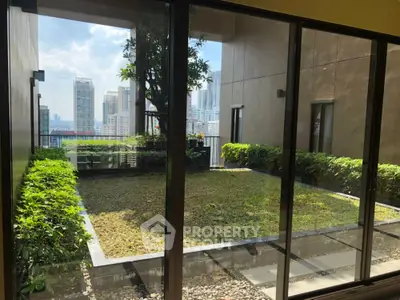 Stunning urban garden view from modern apartment balcony with lush greenery and city skyline.