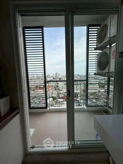 Stunning city view from modern balcony with sliding glass doors and air conditioning units.
