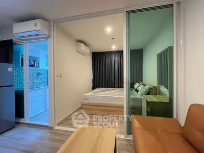 Modern apartment interior with cozy bedroom and living area, featuring sleek design and air conditioning.