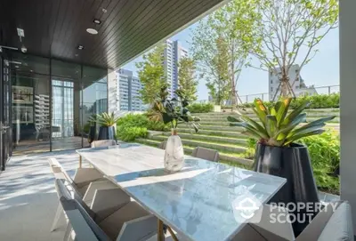 Luxurious outdoor dining area with marble table, modern chairs, and lush garden view, perfect for entertaining in a high-end urban oasis.