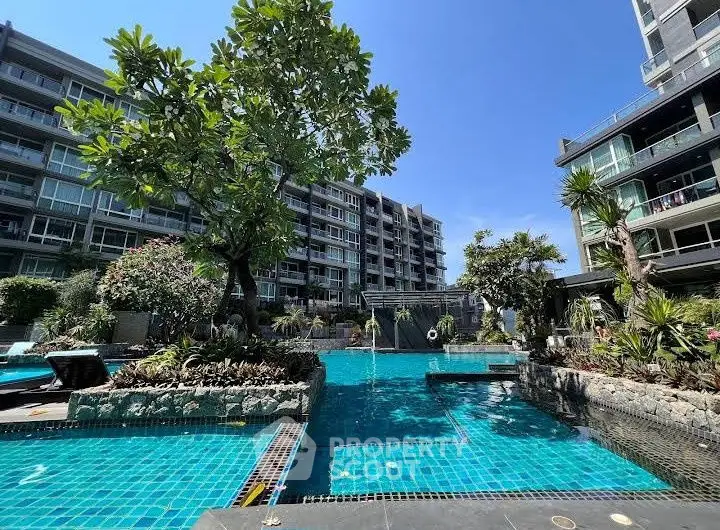 Luxurious condominium with stunning pool and lush garden view
