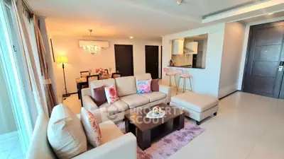 Spacious living room with elegant decor and open kitchen layout in modern apartment.