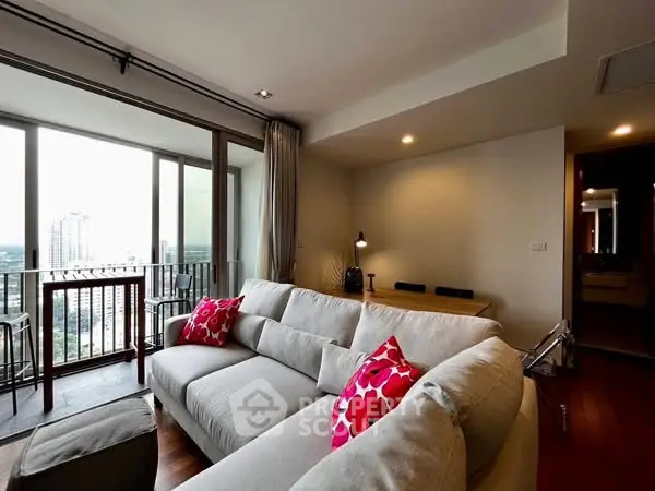Modern living room with large windows and city view, featuring cozy seating and stylish decor.