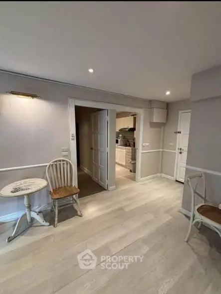 Charming interior with light wood flooring and cozy seating area