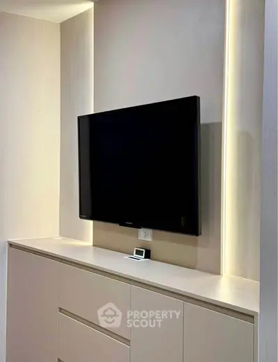 Modern living room with sleek TV setup and ambient lighting