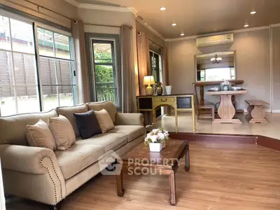 Spacious living room with elegant decor and natural light, perfect for relaxation and entertaining.