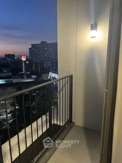Charming balcony with city view at dusk, perfect for relaxation and enjoying the skyline.