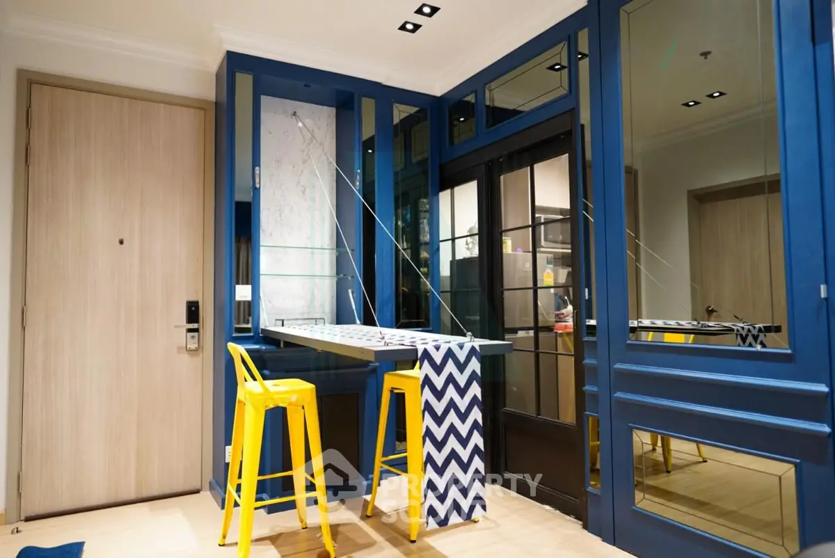 Modern interior with vibrant blue accents and stylish yellow bar stools in a chic living space.