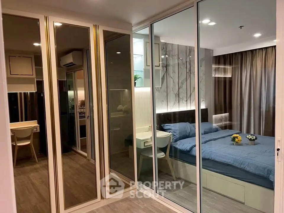 Modern bedroom with mirrored closet and stylish decor