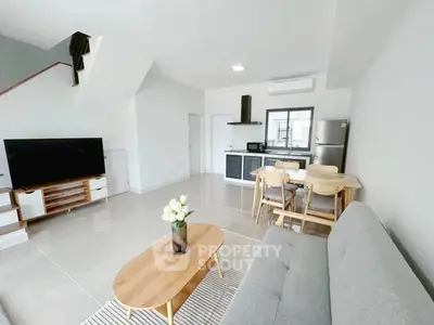Modern open-plan living room with sleek kitchen and stylish furniture