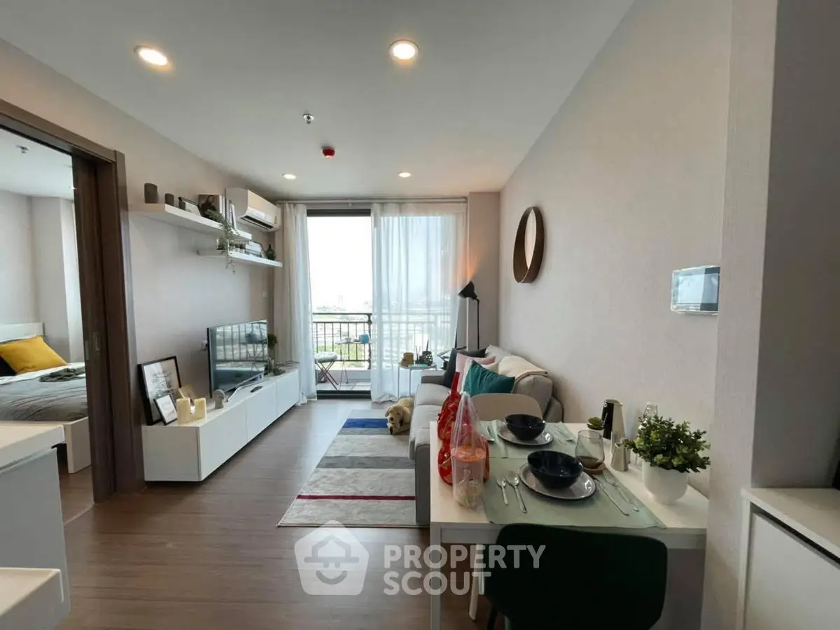 Modern living room with dining area and balcony view in stylish apartment