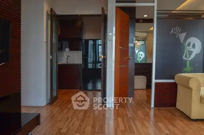 Modern apartment interior with wooden flooring and open kitchen layout
