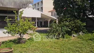 Spacious garden area with lush greenery and modern building exterior