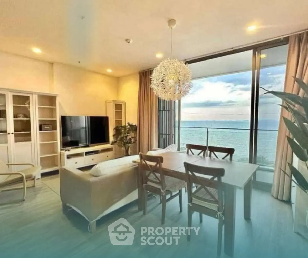 Stunning beachfront living room with panoramic ocean views and modern decor.