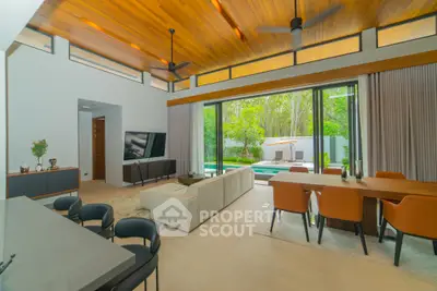 Luxurious open-plan living room with pool view and modern furnishings