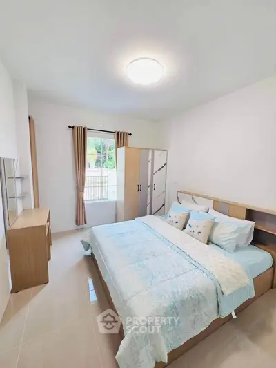 Spacious bedroom with modern decor and natural light