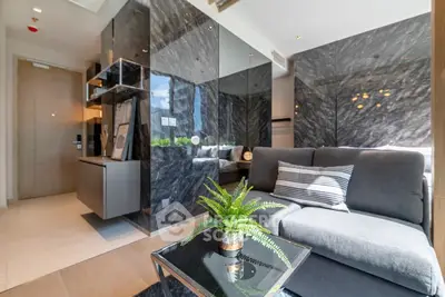 Modern living room with sleek marble walls and cozy gray sofa