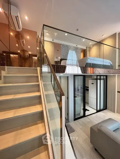 Modern duplex apartment with stylish interior and glass railing staircase
