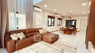 Spacious modern living room with elegant dining area and stylish decor.