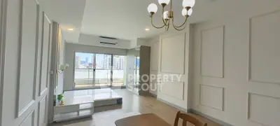 Spacious modern living room with city view and elegant chandelier