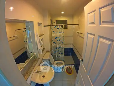 Cozy bathroom with modern fixtures and dolphin-themed shower curtain