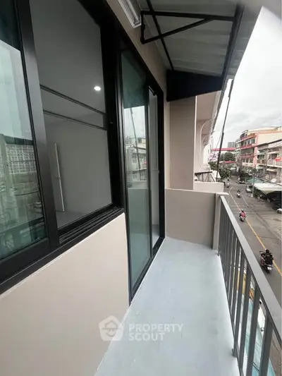 Modern balcony with city view and sleek glass doors