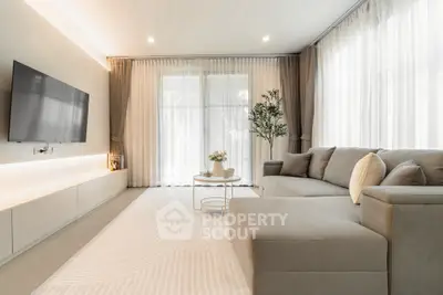Elegant living room with modern decor and large windows for natural light