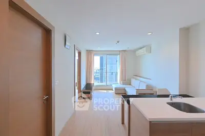 Modern living room with open kitchen and natural light