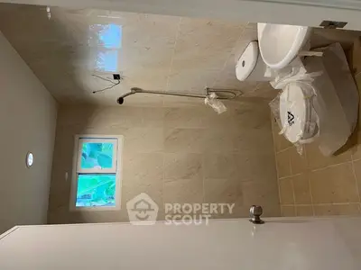 Modern bathroom with sleek fixtures and natural light, featuring a walk-in shower and elegant tile work.