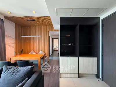 Modern living room with wooden accents and sleek furniture in a stylish apartment.