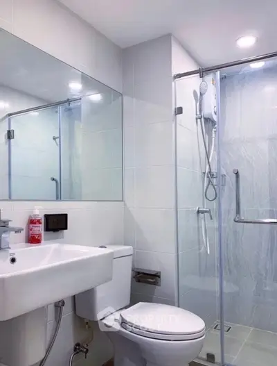 Modern bathroom with glass shower and sleek fixtures