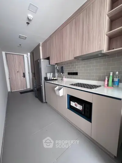 Modern kitchen with sleek cabinetry and built-in appliances in a stylish apartment.