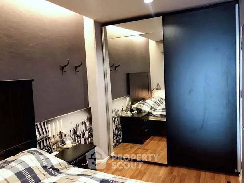Cozy bedroom with mirrored closet and stylish decor