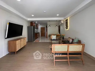 Spacious modern living room with stylish furniture and open kitchen layout