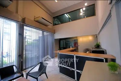 Modern office space with high ceilings and large windows for natural light