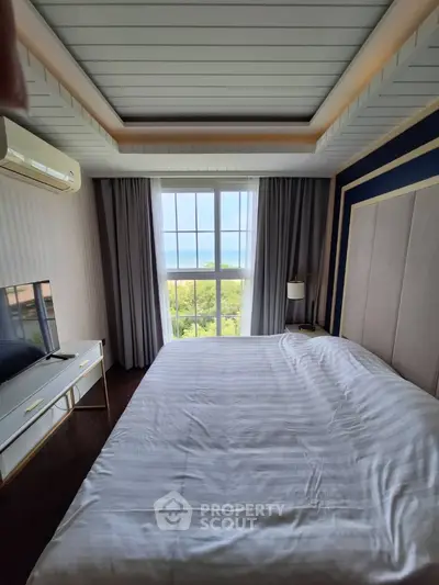Luxurious bedroom with large window and elegant decor