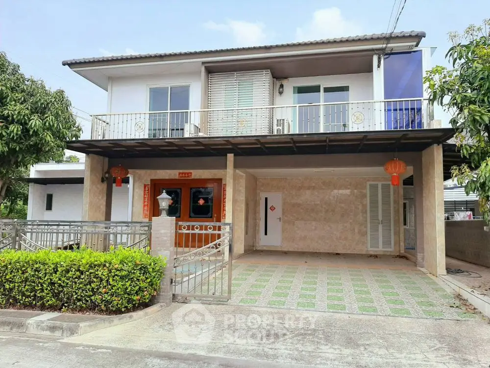 Charming two-story house with spacious driveway and lush greenery, perfect for family living.