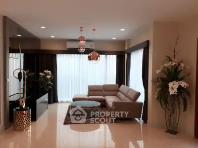 Luxurious modern living room with elegant decor and large windows