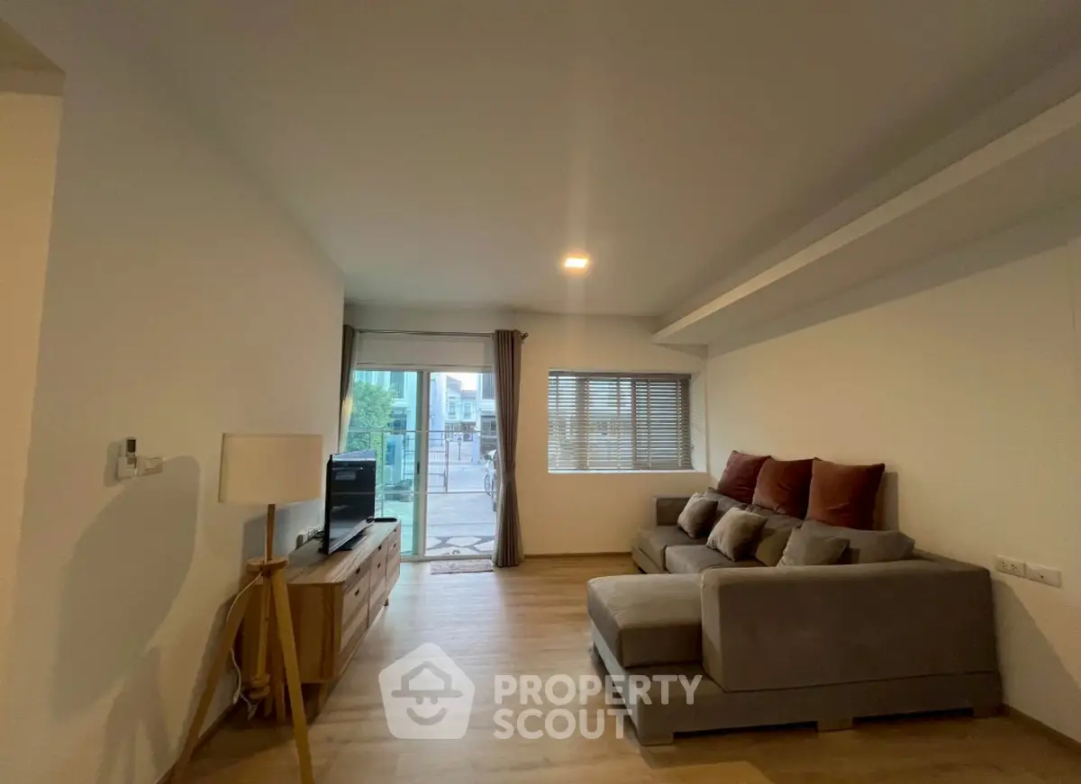 Spacious living room with modern decor and large windows for natural light