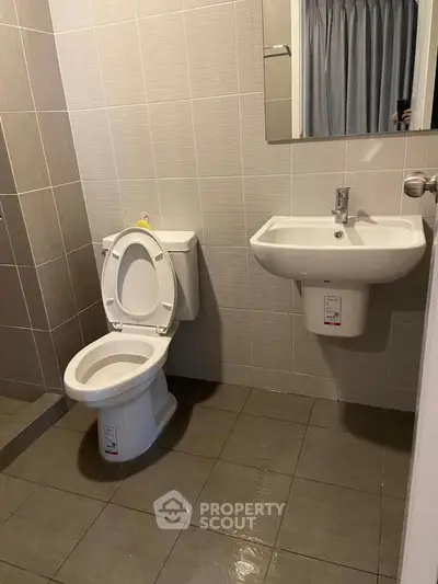 Modern bathroom with sleek tiles and contemporary fixtures.