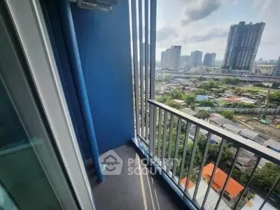 Stunning city view from a modern balcony in a high-rise apartment.