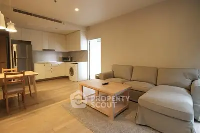 Spacious open-plan living room with modern kitchen and cozy furniture