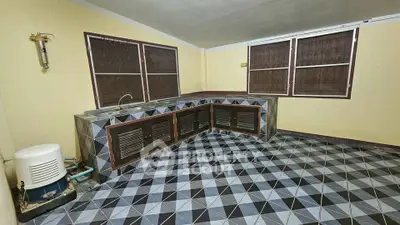 Spacious kitchen with unique geometric tile flooring and ample counter space.