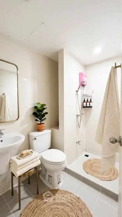 Modern bathroom with shower, toilet, and stylish decor in a cozy apartment.